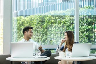 asian couple fun/happy talk or dating at modern co-working space